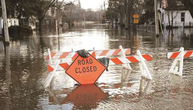 Floodwater from the Pecatonica River cover a road in Freeport, Illinois.