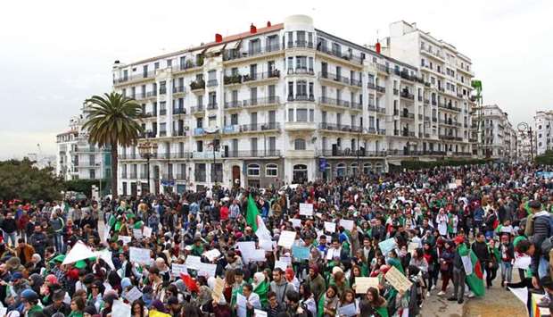 Algerians carry placards and national flags as they take part in a demonstration in the capital Algiers against President Abdelaziz Bouteflika yesterday.