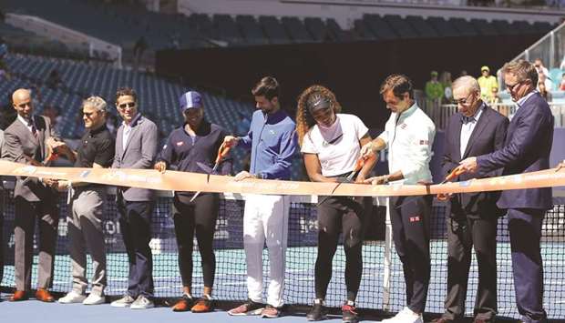 Miami Open tournament director James Blake (left), players Naomi Osaka (fourth from left) of Japan, Novak Djokovic (centre) of Serbia, Serena Williams (fourth from right) of the United States and Roger Federer (third from right) of Switzerland, cut the ribbon during a ceremony on Day 3 of the Miami Open in Miami Gardens, United States, yesterday. (AFP)