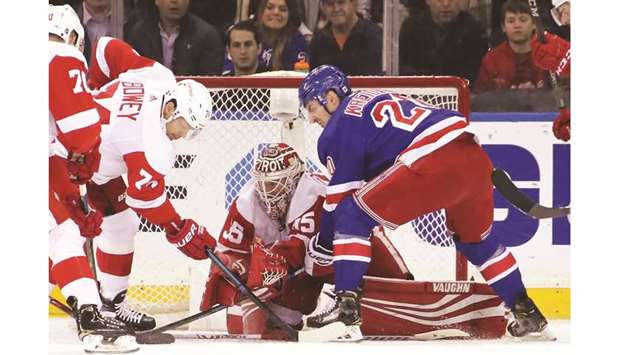 Jimmy Howard of the Detroit Red Wings makes the first period save on Chris Kreider (right) of the New York Rangers at Madison Square Garden in New York City. (Getty Images/AFP)