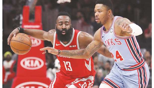 Houston Rockets guard James Harden drives against Atlanta Hawks guard Kent Bazemore in the first quarter of their NBA game at State Farm Arena. PICTURE: USA TODAY Sports