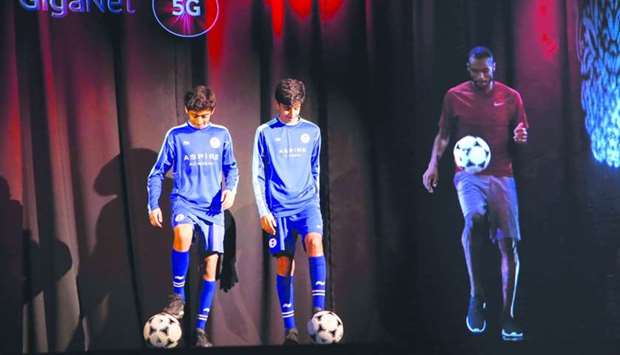 The hologram of Qatar National Team defender Abdulkarim Hassan interacts with young athletes from Aspire Academy. PICTURES: Jayaram.