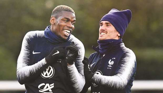 Franceu2019s Paul Pogba (left) jokes with teammate Antoine Griezmann during a training session in Clairefontaine-en-Yvelines yesterday, on the eve of their upcoming Euro 2020 qualification matches against Moldova and Iceland. (AFP)
