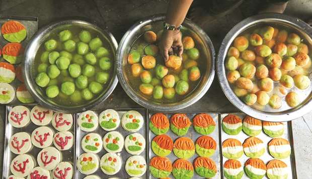 Sweets featuring election symbols of different political parties are seen inside a sweets making workshop on the outskirts of Kolkata yesterday.