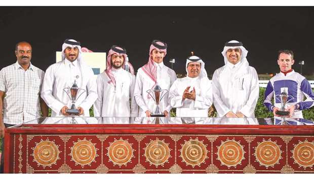 Qatar Racing and Equestrian Clubu2019s Abdulla Rashid al-Kubaisi (third from right) with the winners of the Mesaimeer Cup after Opera Baron won the 1800m dirt feature at Al Rayyan Park yesterday. PICTURES: Juhaim