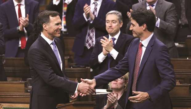 Canadau2019s Prime Minister Justin Trudeau shakes hands with Finance Minister Bill Morneau after Morneau delivered the budget in the House of Commons on Parliament Hill in Ottawa on Tuesday.