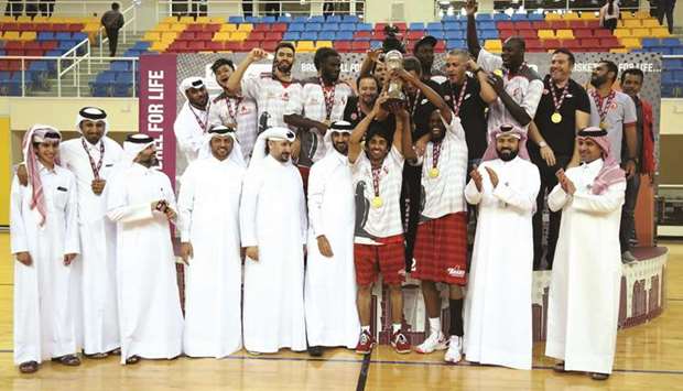 Al Arabi players lift the Qatar Cup trophy in the presence of Qatar Basketball Federation and club officials. PICTURE: Othman Khalid
