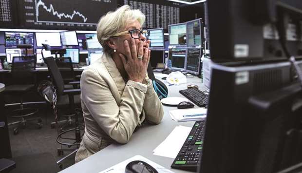 A trader monitors financial data inside the Frankfurt Stock Exchange. The DAX 30 closed down 1.6% to 11,603.89 points yesterday.