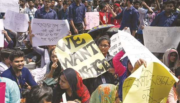 Students hold placards during a protest in Dhaka yesterday, following the death of a student in a road accident on March 19.