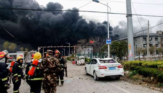 Rescue workers are seen near smoke following an explosion at a chemical industrial park in Xiangshui county, Yancheng, Jiangsu province
