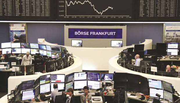 Traders work at the Frankfurt Stock Exchange. The DAX 30 lost 0.5% to 11,549.96 points yesterday.
