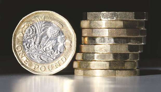 British one pound sterling coins are arranged for a photograph in London (file). The pound could slump as much as 9% from current levels if the UK exited without a deal, according to a Bloomberg survey.