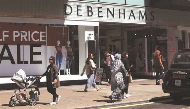 Pedestrians pass a Debenhams department store advertising a half price sale in London. Britainu2019s retail sales grew by an annual 4% in February, the top end of a range of forecasts by economists in a Reuters poll, and down only slightly from Januaryu2019s two-year high of 4.1%, official data showed yesterday.