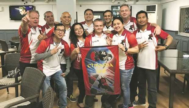Last Samurai team members celebrate their win in the Doha Dart League.