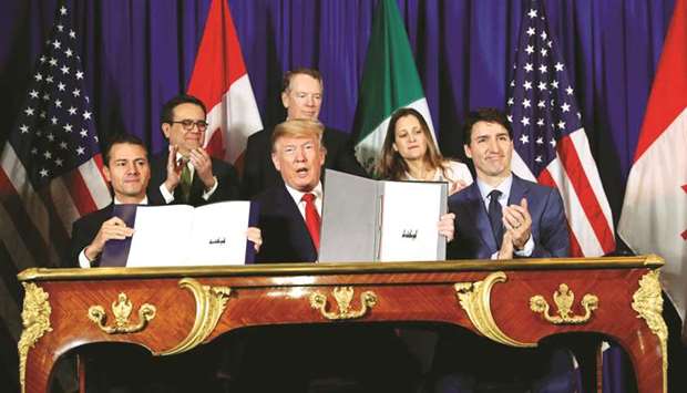 File photo of Enrique Pena Nieto, Mexicou2019s president, US President Donald Trump, and Justin Trudeau, Canadau2019s Prime Minister signing the United States-Mexico-Canada Agreement. Trump believes the US trade deficit reflects unfair practices by Americau2019s counterparts.