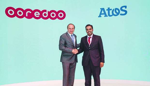 Ooredoo chief business officer Sheikh Nasser bin Hamad bin Nasser al-Thani shakes hands with Atos head of Middle East and Africa and group digital transformation officer Francis Meston.