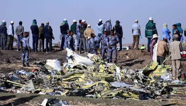 Ethiopian Federal policemen stand at the scene of the Ethiopian Airlines Flight ET 302 plane crash, near the town of Bishoftu, southeast of Addis Ababa