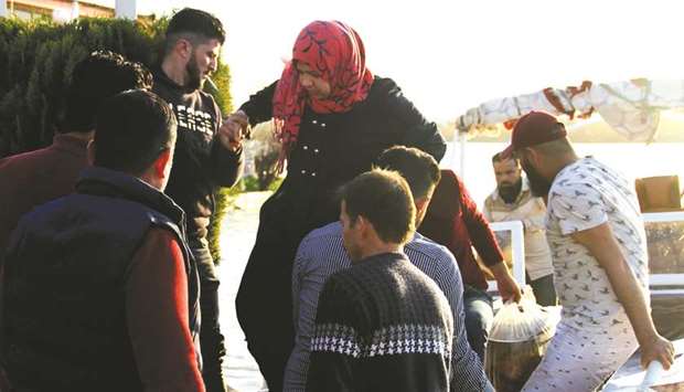 A woman is helped off a boat at the site of a popular picnic area on the Tigris river, after a ferry sank leaving close to 80 people dead in Iraqu2019s worst accident in years.