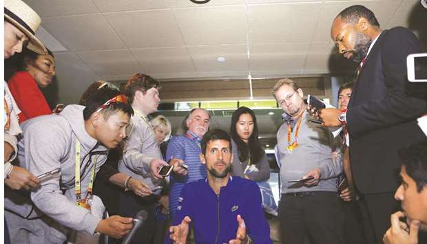 Novak Djokovic (centre) of Serbia fields questions from the media at a player availability session of the Miami Open on Wednesday. (AFP)