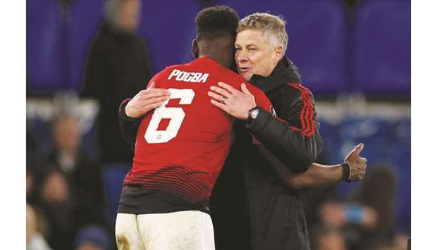 In this February 18, 2019, picture, Manchester United interim manager Ole Gunnar Solskjaer (right) embraces Paul Pogba at the end of the FA Cup fifth round match against Chelsea at Stamford Bridge in London. (Reuters)