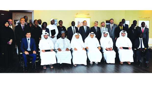 HE the Attorney General and chairman of the Board of Trustees of the Rolacc, Dr Ali bin Fetais al-Marri, HE the Minister of Commerce and Industry Ali bin Ahmed al-Kuwari, and the Gambian ambassador Foday Malang with the graduates of the courses. PICTURE: Shemeer Rasheed