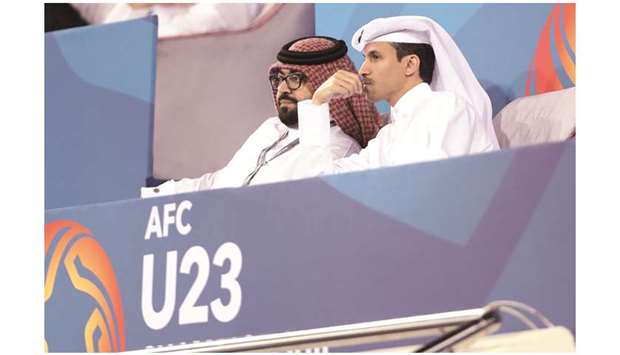 HE Qatar Olympic Committee (QOC) secretary-general Jassim Rashid al-Buenain (right) watches Qataru2019s AFC U23 Championship qualifying match against Afghanistan yesterday. PICTURE: Othman Khalid