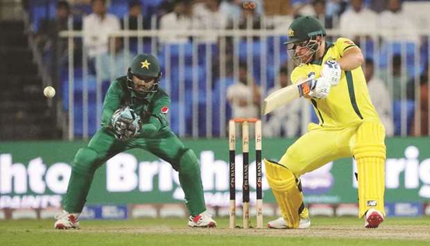 Australiau2019s Aaron Finch (right) plays a shot during the first one-day international (ODI) against Pakistan at Sharjah Cricket Stadium in Sharjah yesterday. (AFP)