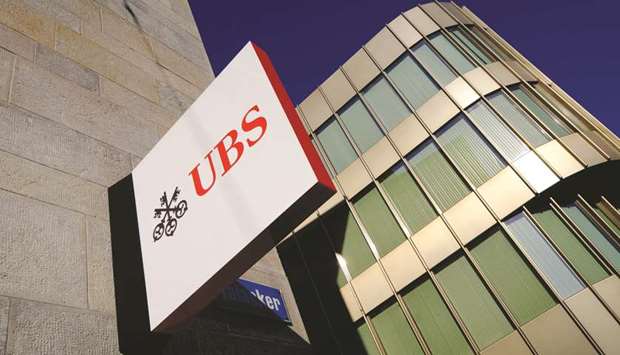 A UBS logo sits on a sign outside its branch in Zurich. UBS is planning to slow down hiring and deepen cost cuts by about $300mn as it confronts one of the worst first-quarter environments in recent history, according to its chief executive officer Sergio Ermotti.