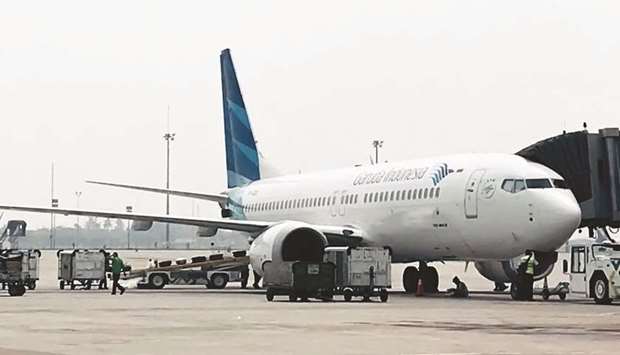 A Garuda Indonesia Boeing 737 Max 8 is seen at Jakarta International Airport. The Indonesiau2019s national carrier will call off a multi-billion-dollar order for 49 Boeing 737 Max 8 jets after two fatal crashes involving the plane, the airline said.