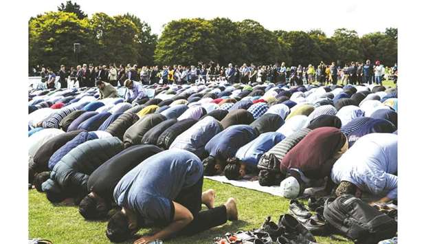 Muslim men pray in a park near the Al Noor Mosque, shortly after a two minutes silence held in memory of the twin mosque massacre victims in Christchurch.