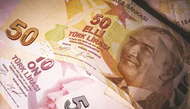 A selection of Turkish lira banknotes sit on a table in London. The lira lost nearly 30% against the dollar last year as investors worried about the central banku2019s ability to curb inflation in the face of calls from President Recep Tayyip Erdogan for lower borrowing costs.