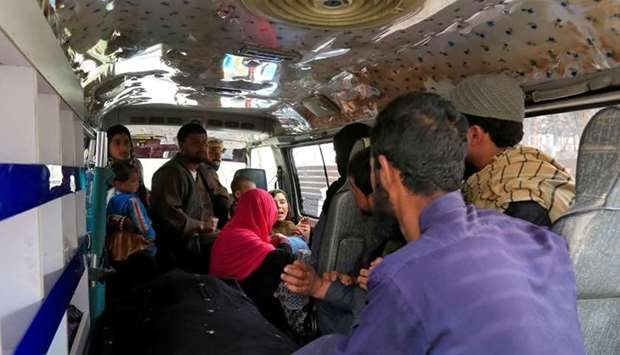 A family reacts inside an ambulance after they lost a family member after multiple explosions on Thursday in Kabul, Afghanistan