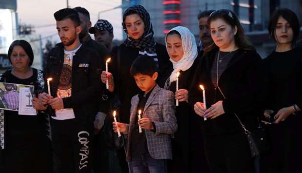 Iraqi Kurds light up candles in Arbil, the capital of the Kurdish autonomous region in northern Iraq, yesterday, in remembrance for the victims of the capsized ferry in Mosul.