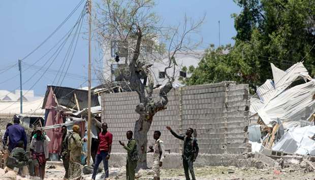 omali security officers secure the scene after al-Shabaab militia stormed a government building in Mogadishu.