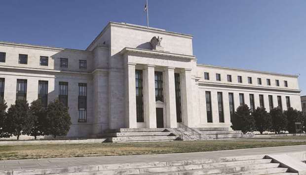 The Federal Reserve Board building in Washington. The Fed surprised investors on Wednesday by slashing rate projections to show no hike this year.