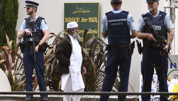 Members of the local Muslim community wait to enter the Al Noor mosque as it is reopened in Christchurch