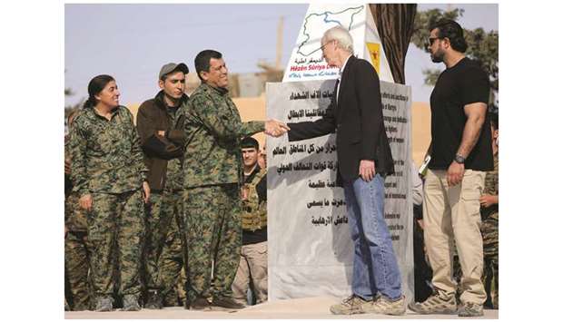 Mazloum Kobani, SDFu2019s commander in chief, shakes hands with the adviser for the US Department of State in northern Syria William Roebuck, at Al-Omar oil field in Deir Ezzor, yesterday.