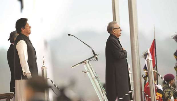 Pakistani Prime Minister Imran Khan (left) and President Arif Alvi (right) stand silent during the national anthem during the Pakistan Day parade in Islamabad yesterday.