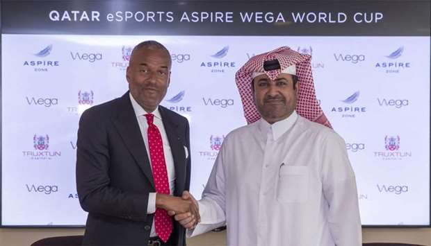 Abdullah Nasser al-Naemi and Patrick Moynier shake hands after the signing the agreement.rnrn