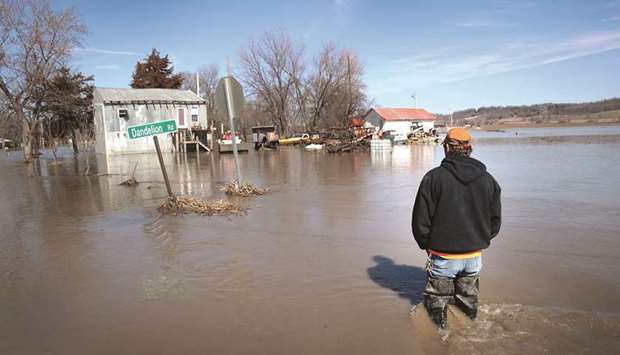 Brian Nutchler walks through floodwater to his home on Friday in Craig, Missouri.