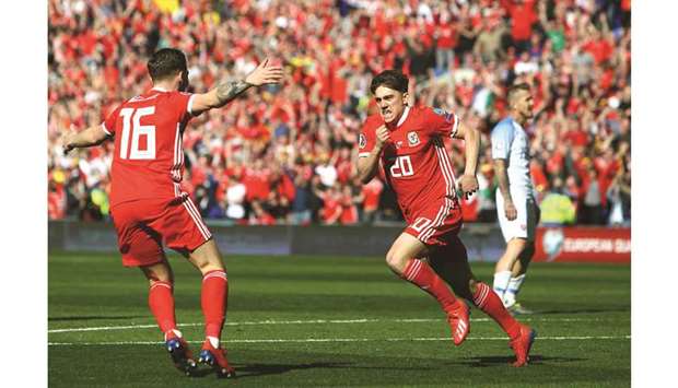 Walesu2019 midfielder Daniel James (right) celebrates with teammate after scoring against  Slovakia during the UEFA Euro 2020 Group E qualification match in Cardiff. (AFP)