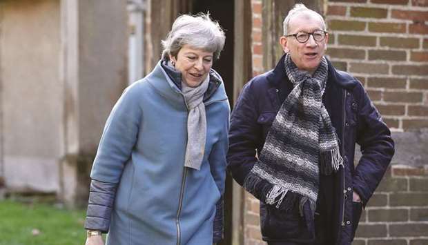 Prime Minister Theresa May leaves with her husband Philip after attending a church service, near her Maidenhead constituency, west of London, yesterday.
