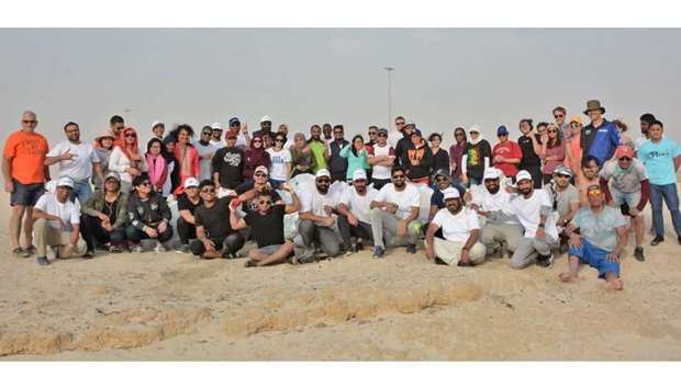 GROUP: Doha Environmental Actions Project (DEAP) volunteers during their 100th beach clean-up activity at As Salwa beach.