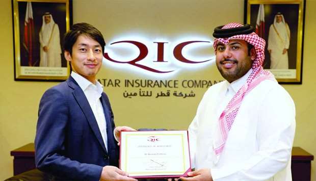Ahmed al-Jarboey, senior vice president Mena Retail & Motor Claims, awards a certificate of achievement to Kazutaka Yoshiyasu, who was sent by Sompo Japan Nipponkoa Insurance Inc to QIC Headquarters in Doha for enhancing technical skills, exchanging experiences, and adopting best practices.