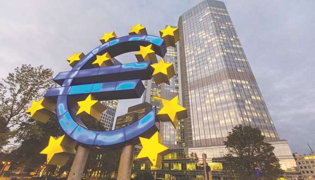 File photo: A euro sign sculpture stands illuminated in front of the European Central Bank (ECB) headquarters in Frankfurt, Germany. Europeu2019s current situation demonstrates amply the non-existence of the magical real interest rate.