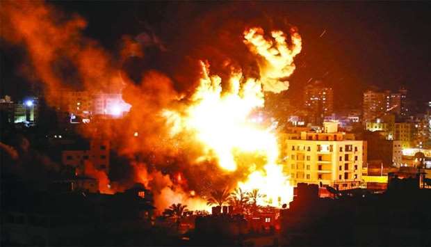 Fire and smoke below above buildings in Gaza City during Israeli strikes on Monday. Israel's military launched strikes on Hamas targets in the Gaza Strip, the army and witnesses said, hours after a rocket from the Palestinian enclave hit a house and wounded seven Israelis.
