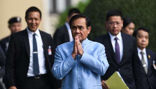 Thailand's Prime Minister Prayut Chan-O-Cha (C) arrives at the Government House for a cabinet meeting in Bangkok