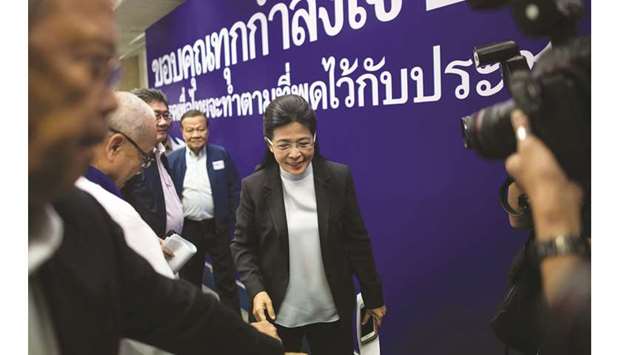 Pheu Thai partyu2019s candidate for prime minister Sudarat Keyuraphan, centre, leaves after speaking at a press conference in Bangkok yesterday after Thailandu2019s general election.