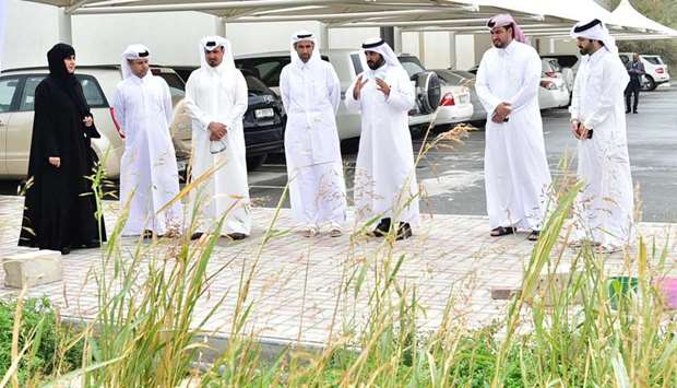 Representatives get a firsthand look at the soil testing project.