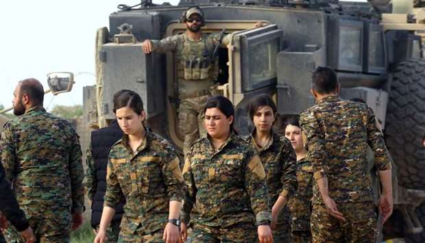 Fighters of Syrian Democratic Forces (SDF) walk together at al-Omar oil field in Deir Al Zor